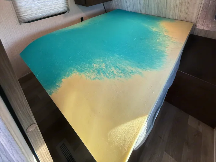 Enhance your rv rental comfort with this memory foam mattress topper, featuring a blue cooling gel layer on a yellow base.. Heartland RVs Pioneer 2021