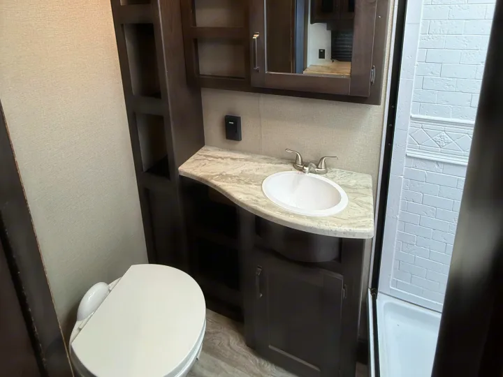 RV rental bathroom: toilet, sink, shower, and vanity with storage. Ready for your next adventure.. Grand Design Transcend Xplor 2022