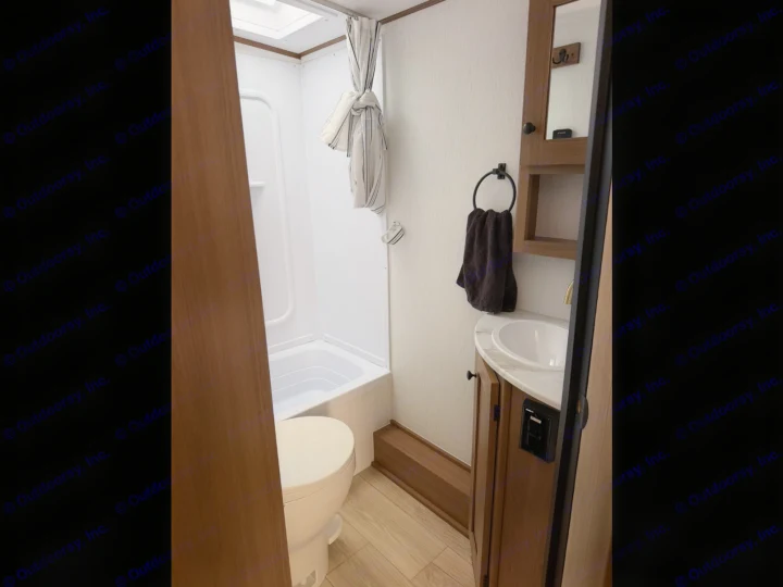 This clean, compact RV rental bathroom features a shower, toilet, and vanity with a sink, ideal for travel.. Coachmen Apex Nano 2026