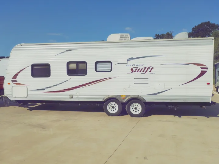 White Jayco Jay Flight Swift travel trailer for RV rental. Perfect for your outdoor adventure and camping trips.. Jayco Jay Flight Swift 2014