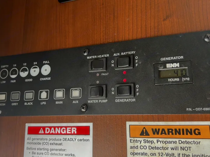 RV rental control panel for tank, battery, & generator (410 hrs) status, plus water heater/pump switches.. Tioga Montara 2013