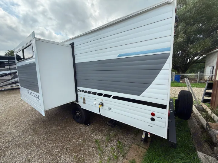 White & gray Salem FSX travel trailer with slide-out extended. Ideal for an rv rental adventure, ready for hookups.. Forest River Salem 2026