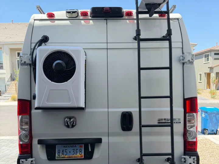 Customized white Ram ProMaster van rv rental with exterior AC unit, roof access ladder, and satellite internet.. Dodge Ram 2500 2024