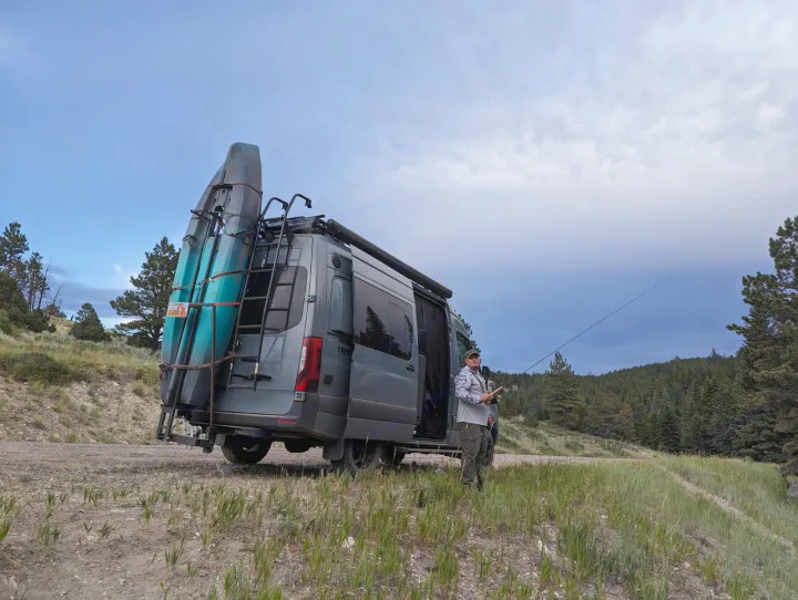 Exploring nature with an rv rental van, kayaks & a person ready to fish. Perfect outdoor adventure!. Jayco Terrain 2023