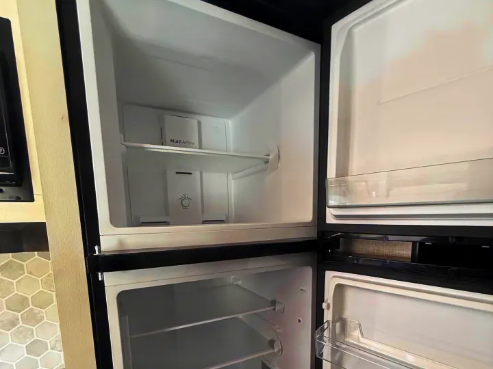 Empty RV rental refrigerator interior, showing a "Multi Airflow" panel and shelves, ready for your trip's provisions.. Jayco Jay Flight 2024