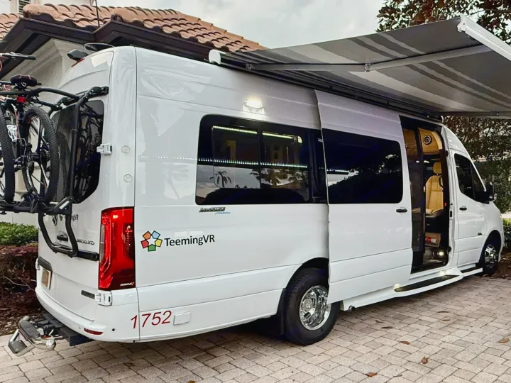White Mercedes Sprinter camper van RV rental, ready for adventure with bikes and extended awning.. Midwest Automotive Designs Midwest Automotive Designs Class B 2023