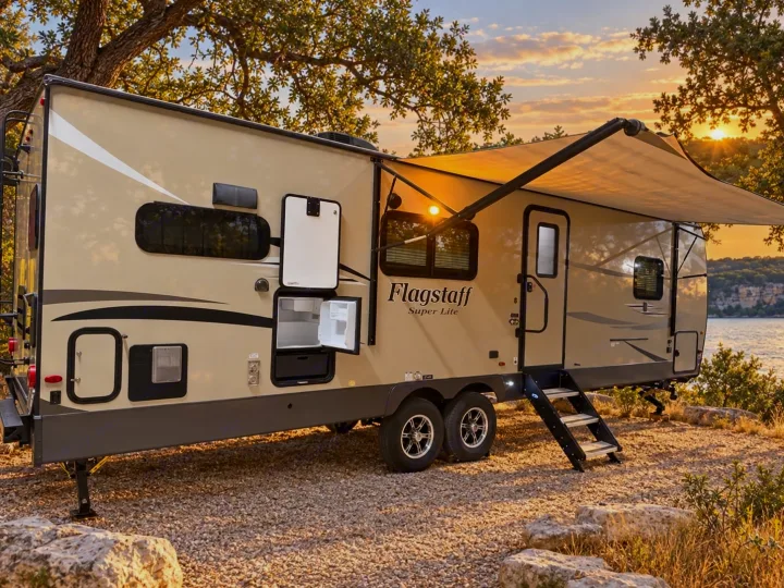 This Flagstaff Super Lite RV rental offers comfortable camping. Awning out, steps down, and lakeside at sunset for your next adventure!. Forest River Flagstaff Super Lite 2018