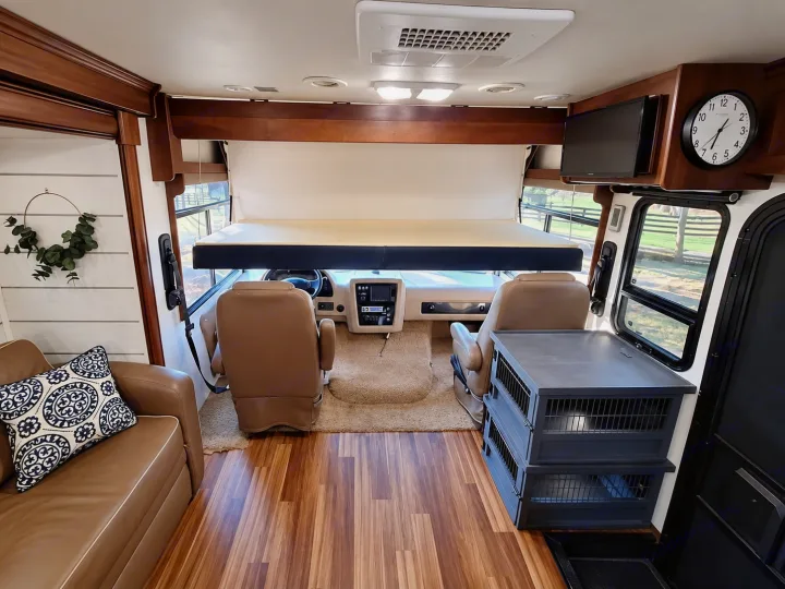 Modern RV rental interior: drop-down bunk, cockpit, sofa, and pet-friendly crates. Enjoy comfortable travel for everyone.. Georgetown Georgetown Motorhome 2014