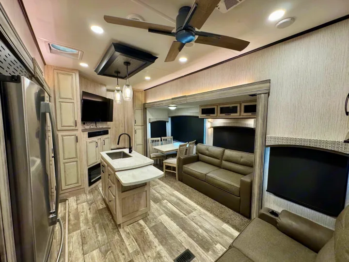 Spacious RV rental interior featuring a modern kitchen, dining area, and comfortable living space.. Forest River Sandpiper 2022