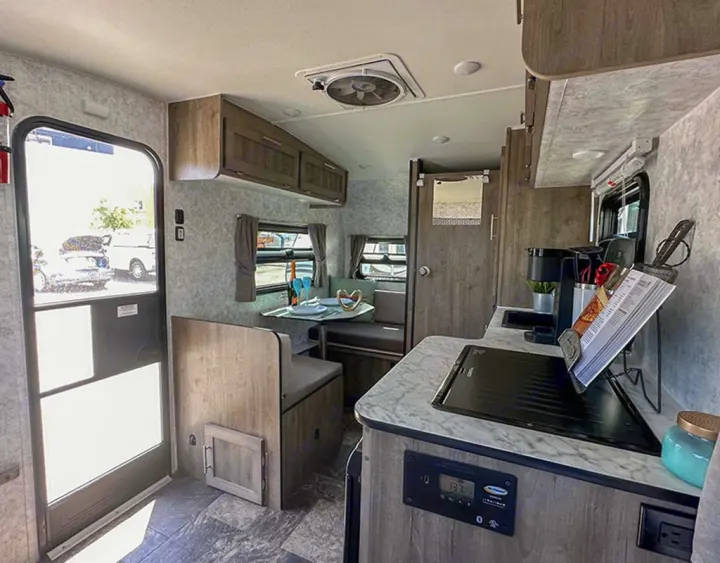 This RV rental offers a cozy dinette, well-equipped kitchenette with coffee maker, and comfortable living space for your journeys.. Prolite Lounge 2022