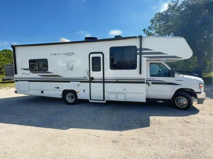 A white Freelander Class C RV rental is parked outdoors, ready for a sunny road trip or camping adventure.. Coachmen Freelander Freelander 2022