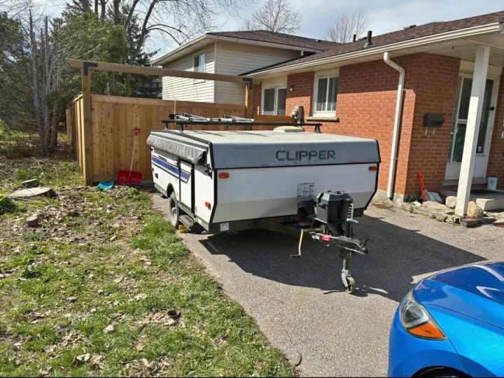 A Clipper pop-up camper/RV trailer, perfect for rv rental adventures, parked on a driveway.. Coachmen clipper 2020