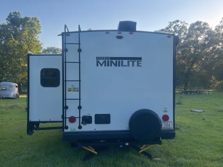 Experience travel freedom with this Rockwood Mini Lite travel trailer. Perfect for an RV rental adventure, featuring a ladder and spare tire.. Rockwood Mini Lite 2104S 2023