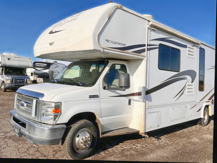 A white Fleetwood Class C rv rental on a Ford E-series chassis, parked outdoors, ready for your next road trip adventure.. Tioga Montara 2013