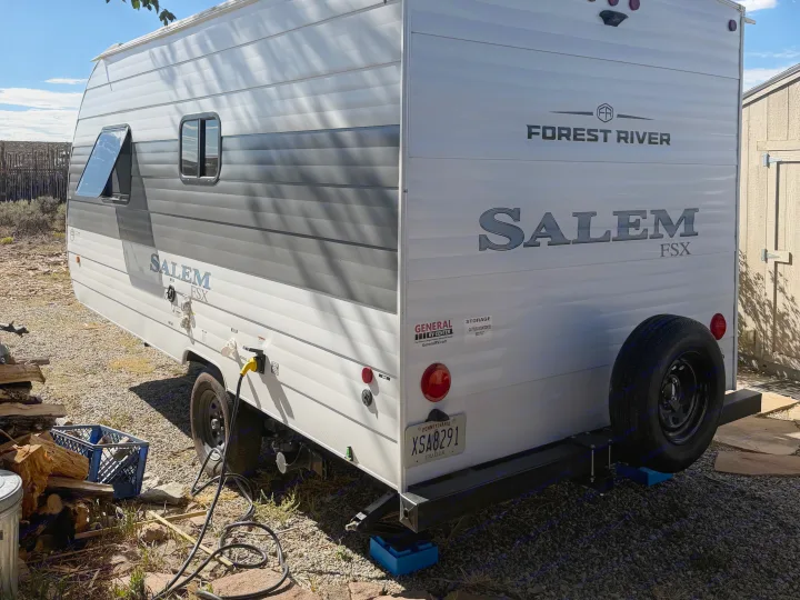 This Forest River Salem FSX travel trailer, an RV rental, is parked on a gravel lot, ready for camping adventures.. Forest River Salem FSX 2026