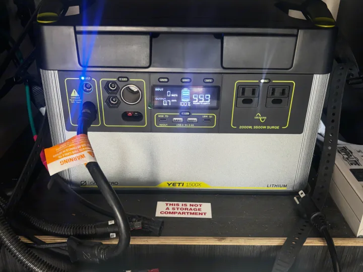 Goal Zero Yeti 1500X portable power station displays 100% charge and 99.9 hrs remaining. Ideal for RV rental off-grid power.. Mobile Scout Dodge Ram 2500 2021