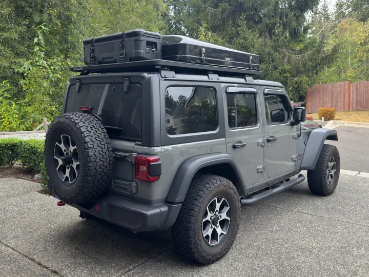 Adventure-ready grey Jeep Wrangler RV rental with a rooftop tent and cargo box, perfect for overlanding and camping.. Jeep Wrangler Rubicon Unlimited 2021