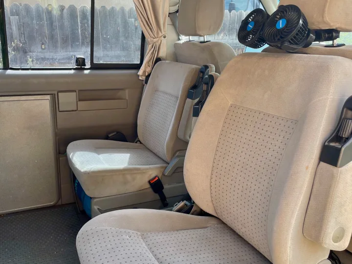 RV rental van interior: light fabric seats, headrest fans, and windows with privacy curtains and screens.. Eurovan Camper Eurovan Camper Class B 2002