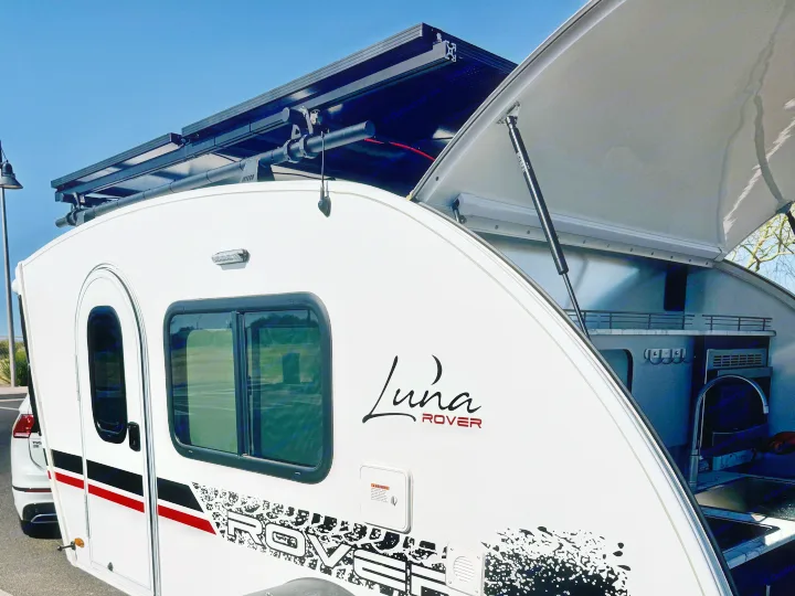 Explore with this Luna Rover teardrop RV rental! Its rear hatch reveals a fully equipped mobile kitchenette, ideal for camping adventures.. InTech RV Luna 2022