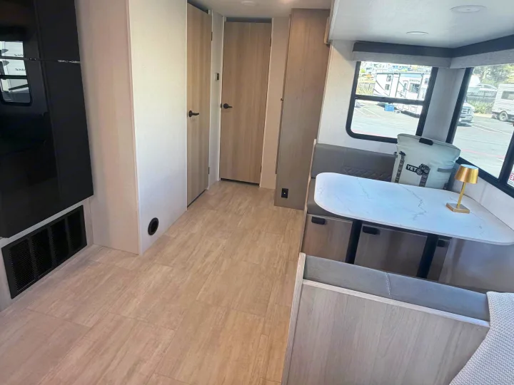 Step inside this clean rv rental with a modern dinette, comfy booth, and light wood floors. Perfect for your next trip!. Dutchmen Kodiak 2026