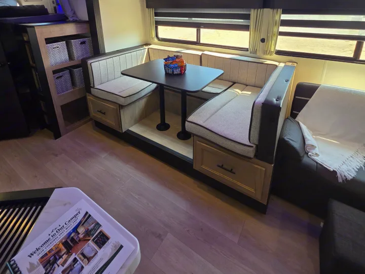 Cozy rv rental dinette with snacks, storage, and comfy seating. Ideal for family adventures in a modern camper.. Forest River Cherokee Grey Wolf 26KF 2026