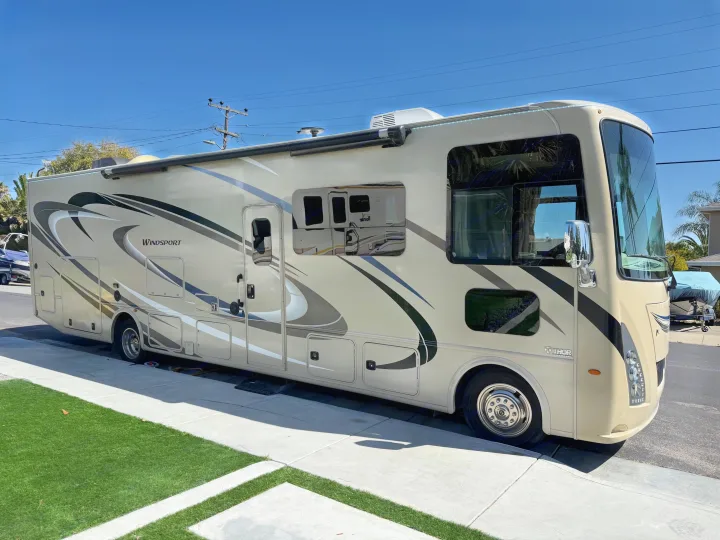 Spacious Thor Windsport Class A RV rental, tan exterior with graphics, ready for your next road trip adventure.. Thor Windsport 2018