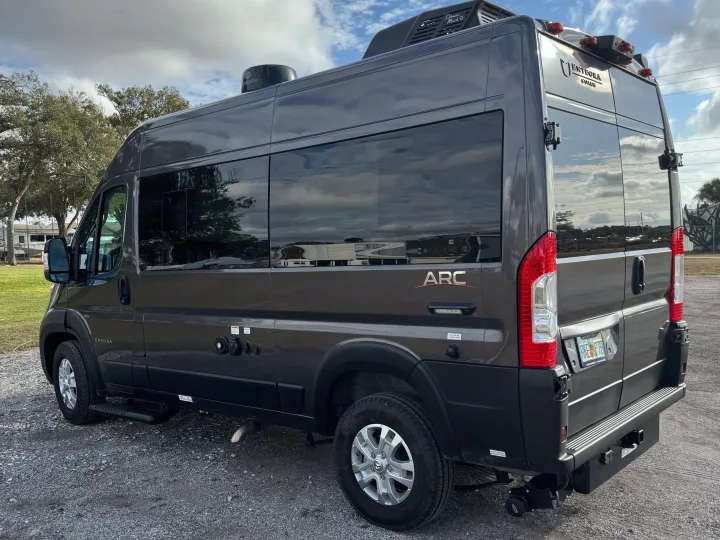 This dark grey Entegra Coach ARC RV rental features utility hookups and a rooftop AC unit.. Entegra Coach ARC 2025