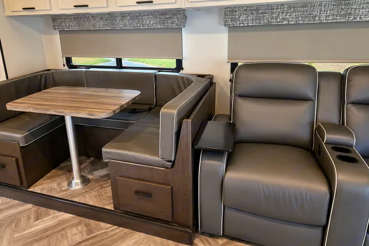 RV rental: Modern interior with a dark gray U-shaped dinette and recliners, perfect for meals and relaxation.. Forester Classic 2021