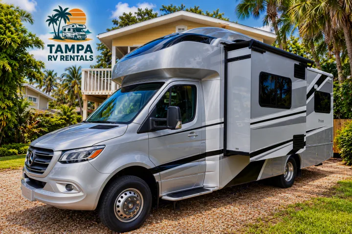 Experience luxury travel with this silver RV rental. Parked in sunny Florida among palm trees, ready for your Tampa adventure.. Tiffin Wayfarer 2020