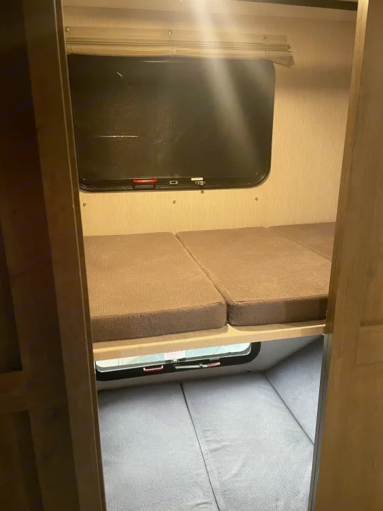RV rental bunk beds with cushions on two levels. Each bunk has a window for a compact, functional sleeping area.. Coachmen MIRADA 35ESF 2026