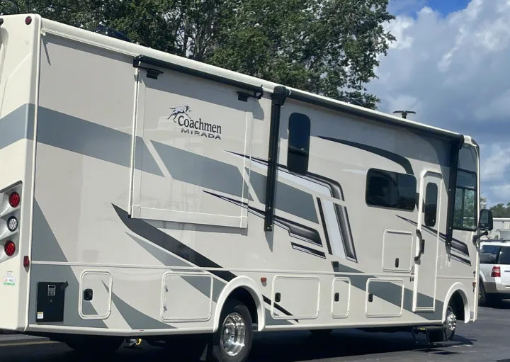 This Coachmen Mirada RV rental, with its beige and grey design, is parked and ready for your next travel adventure.. Coachmen MIRADA 35ESF 2026