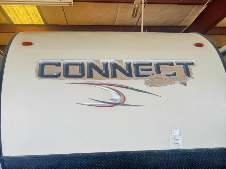 Experience freedom with a 'CONNECT Spree' travel trailer, ideal for an RV rental getaway. Front view details branding.. KZ C291IKS 2015