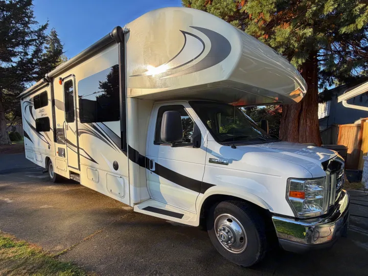 White Jayco Greyhawk Class C RV rental parked outdoors, ready for your next travel adventure under a clear blue sky.. Jayco Greyhawk 2016