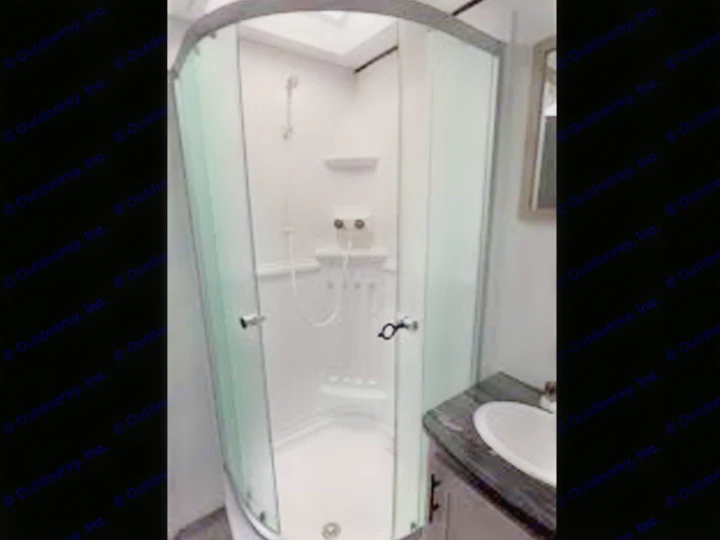 RV rental bathroom featuring a bright corner shower with glass doors and a modern sink vanity.. Heartland RVs Prowler 2022