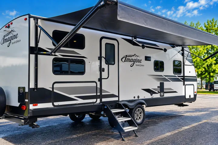 Rent this white Imagine Grand Design travel trailer, featuring an extended awning and entry steps, perfect for your next RV adventure.. Grand Design Imagine 2021