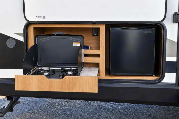 This RV rental features a convenient outdoor kitchen with a slide-out stove and Everchill mini-fridge for easy camping meals.. Grand Design Imagine 2021