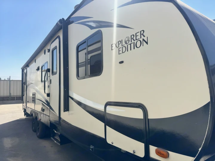 A modern beige and black "EXPLORER EDITION" travel trailer, ideal for your next RV rental adventure.. Forest River 270BHS 2016