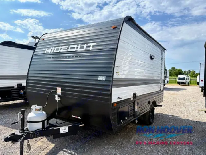 New Hideout by Keystone travel trailer with dark gray and white exterior, propane tank. Perfect for an RV rental adventure.. Hideout Sport 140RE 2025