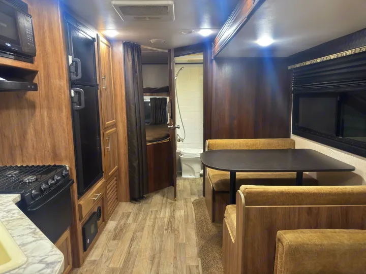 This RV rental interior features a kitchen, dinette, bunk beds, and bathroom for comfortable travels.. Jayco Jay Feather 2018