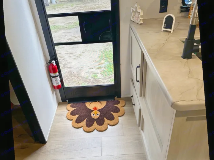 Safety and comfort in an RV rental: fire extinguisher, cute turkey doormat, and kitchen area ready for adventure.. Forest River Palomino Puma Camping Edition 2025