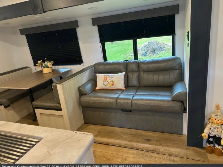 Cozy RV rental interior featuring a comfortable dinette, sofa with fall decor, and modern finishes, ideal for travel.. Forest River Palomino Puma Camping Edition 2025