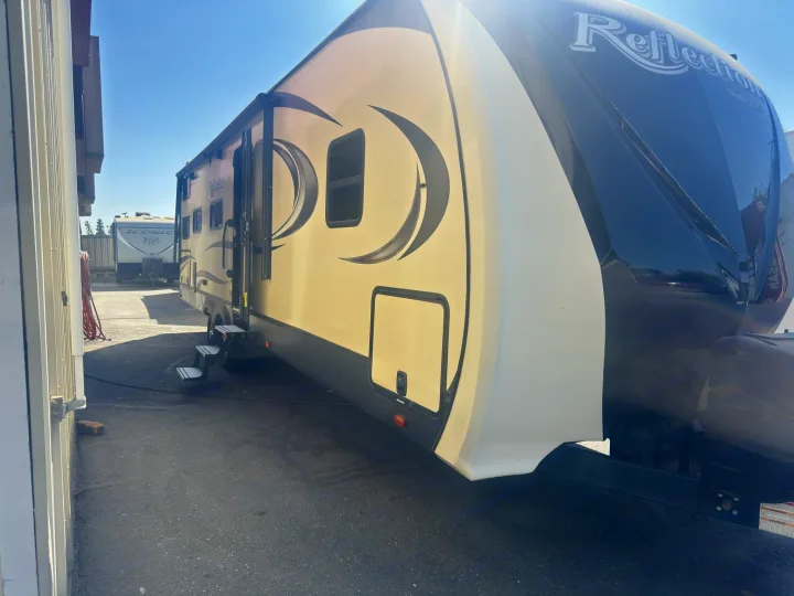 RV rental: Tan & dark Grand Design Reflection travel trailer with steps, parked outdoors, ready for adventure.. Grand Design Reflection 2019