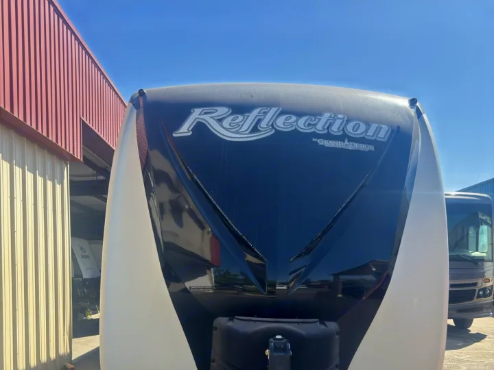 Frontal view of a white and black Grand Design Reflection RV trailer, ideal for an RV rental journey.. Grand Design Reflection 2019