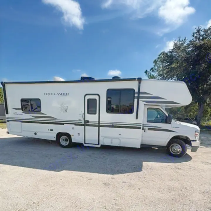 White Freelander motorhome parked outdoors under a blue sky, ready for your next rv rental adventure.. Coachmen Freelander Freelander 2022