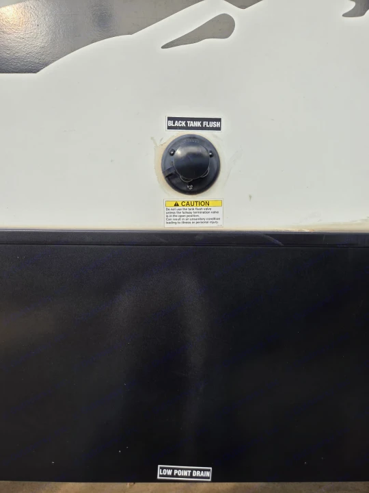 RV rental features: Black Tank Flush hookup (with safety caution) and a Low Point Drain label. Important for waste disposal.. Alta 2850KRL 2021