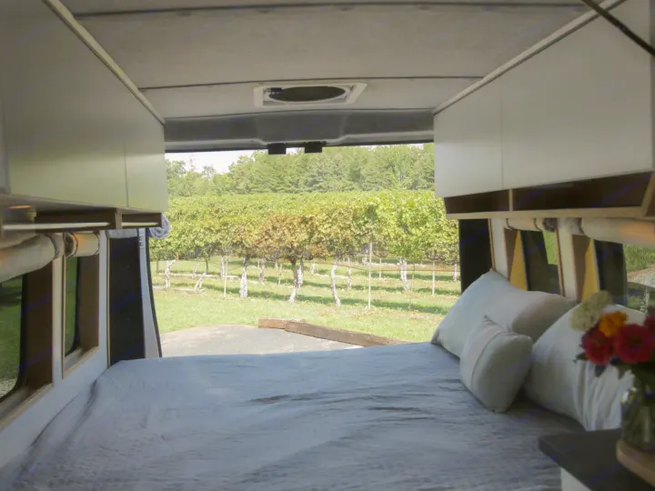 Relax in this RV rental van: cozy bed, overhead cabinets, & stunning vineyard view. Ideal for travel & adventure.. Dodge Sprinter Van 2016