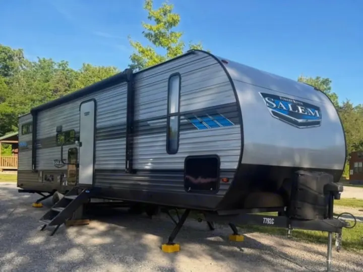This Forest River Salem RV rental is set up at a scenic campground, ready for your next outdoor adventure.. Forest River Salem 2022