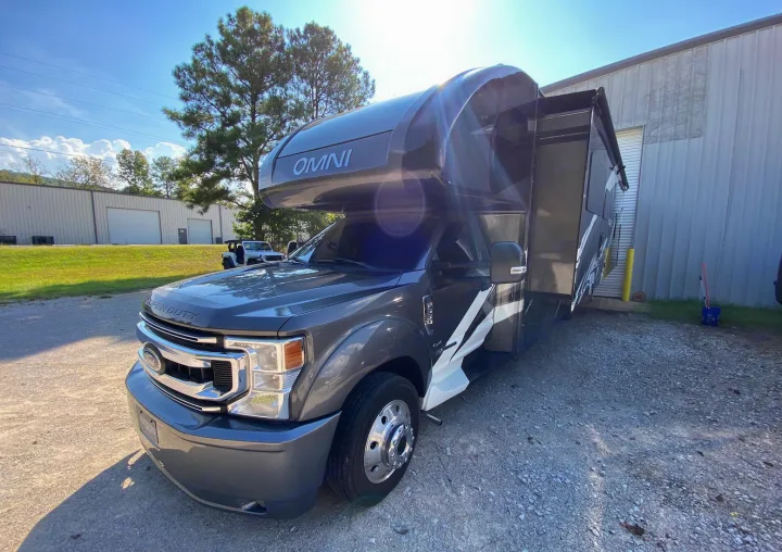 This gray Ford Super Duty Omni RV rental, with a slide-out extended, is ready for outdoor adventures.. Thor Super C 2021