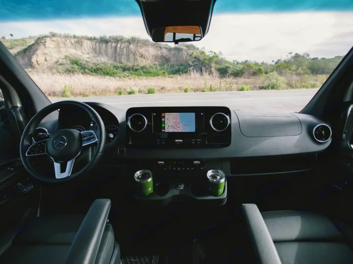 Dashboard view of an RV rental Mercedes Sprinter van, navigating a scenic road. Perfect for your next road trip adventure!. Vanspeed Vanspeed Class B 2021