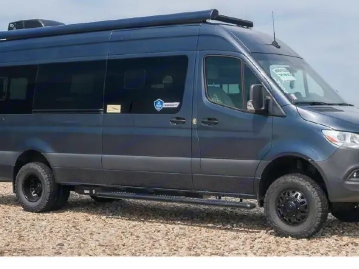 RV rental: Dark grey Mercedes-Benz Sprinter camper van, equipped for adventure with off-road tires & awning.. Thor Tranquility 2025
